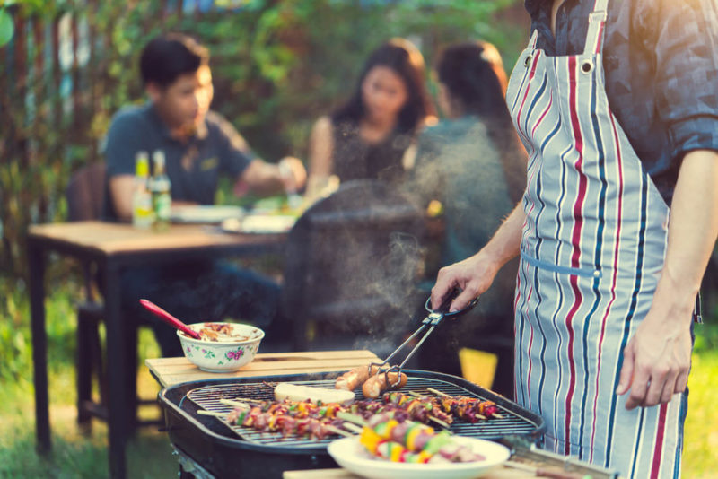 Man barbecuing - townhouse versus condo